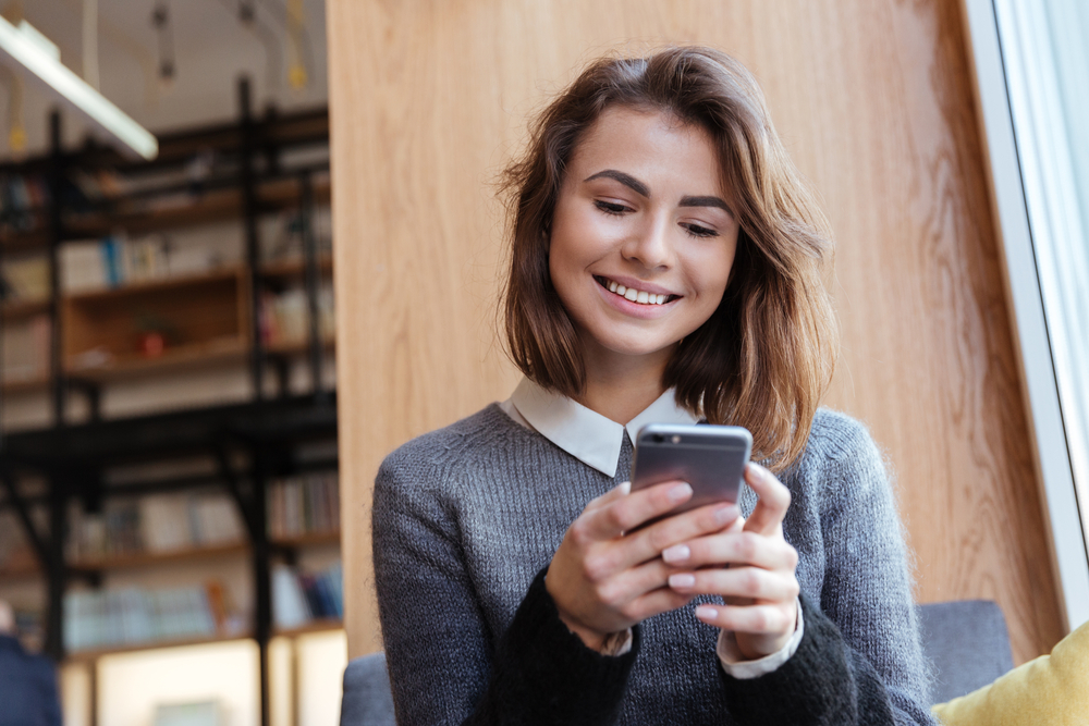 Young woman looking at her phone