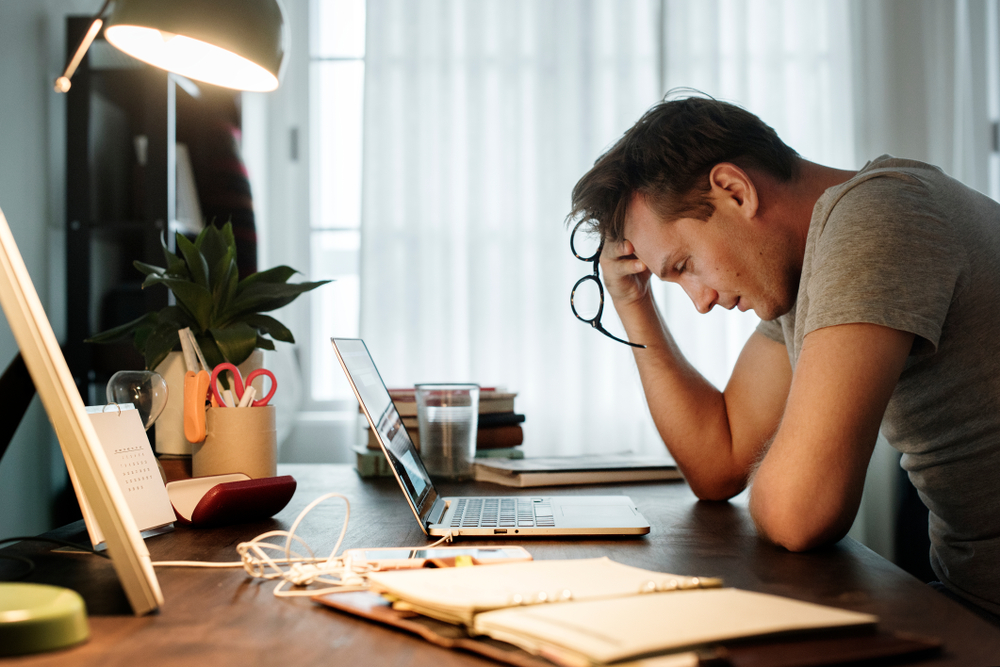 Stressed man sitting at his desk