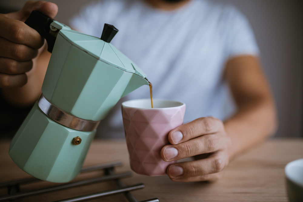 Man pouring coffee into a cup