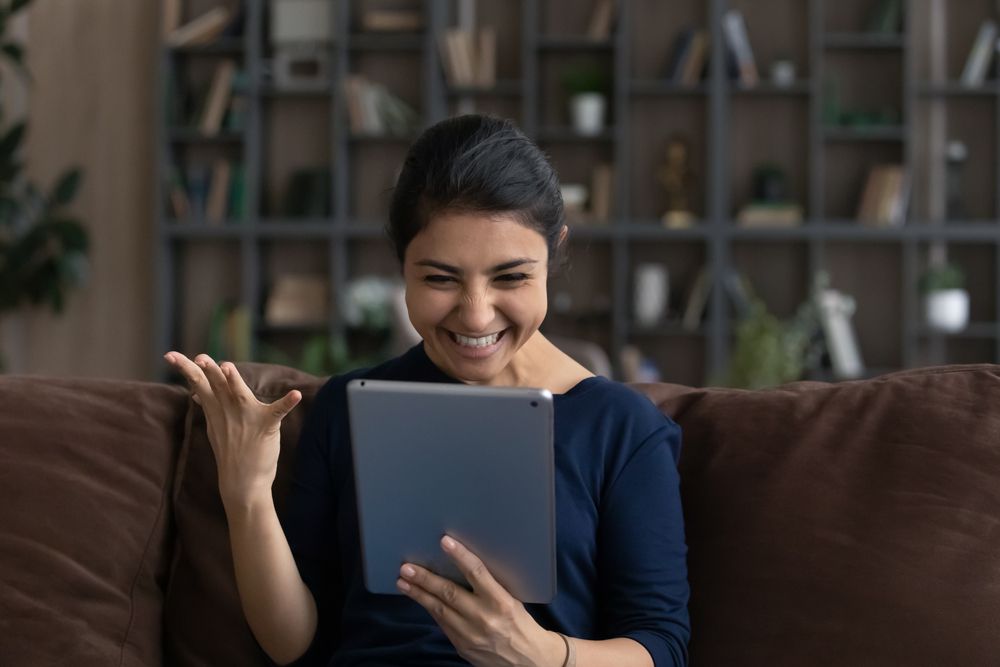 Happy woman looking at her tablet 