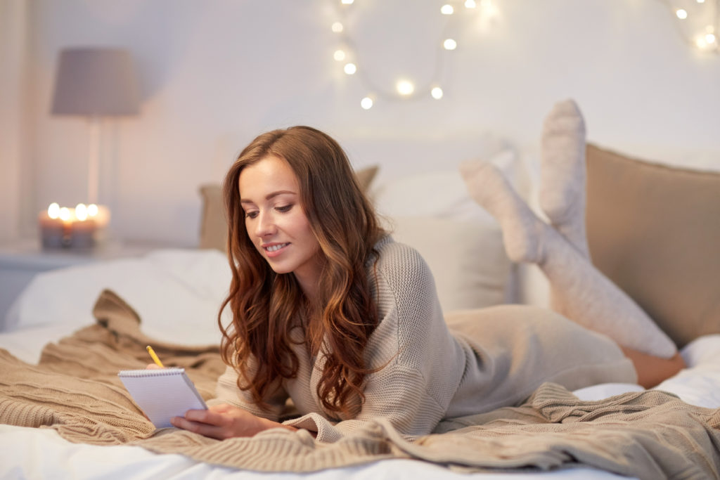 Woman writing her holiday gift list