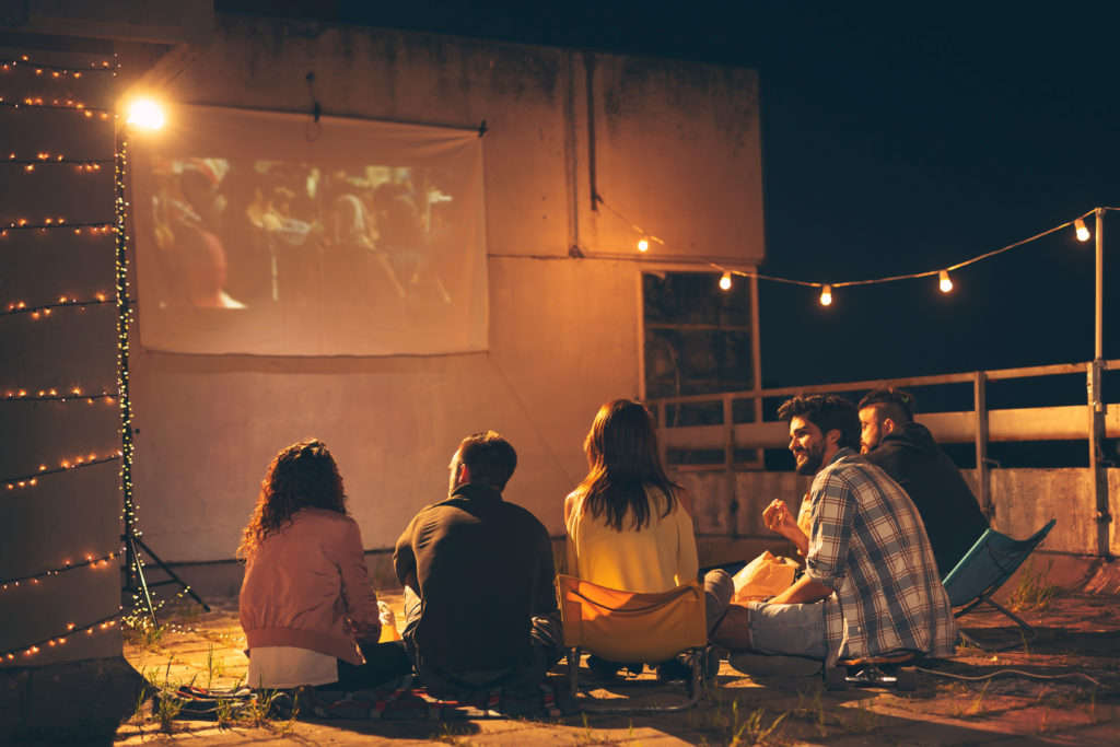 Friends watching a movie together outdoors